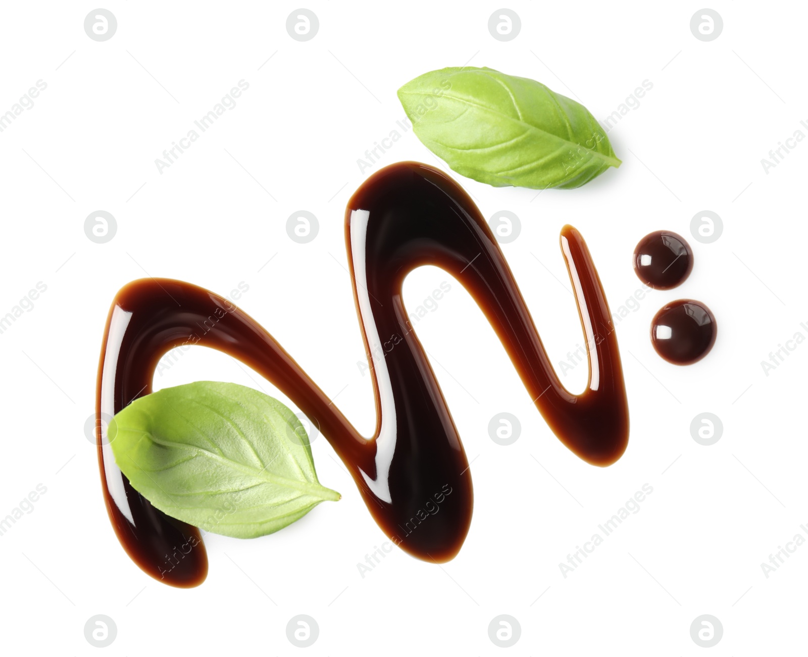 Photo of Delicious balsamic vinegar and basil leaves isolated on white, top view