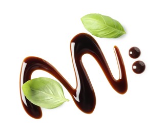 Photo of Delicious balsamic vinegar and basil leaves isolated on white, top view