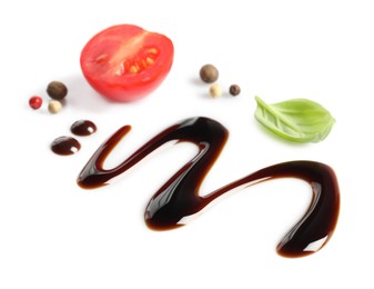 Photo of Delicious balsamic vinegar, cut tomato, basil and peppercorns isolated on white