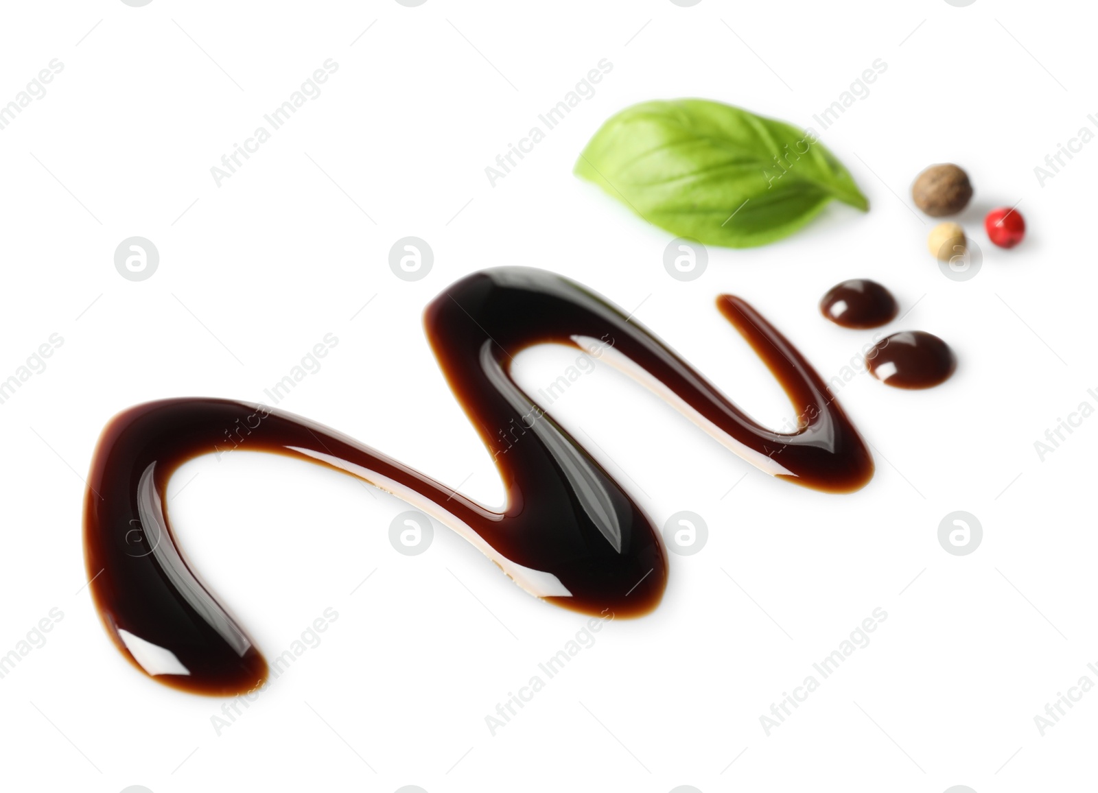 Photo of Delicious balsamic vinegar, basil and peppercorns isolated on white