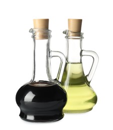 Balsamic vinegar and oil in glass jugs isolated on white