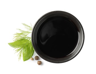 Balsamic vinegar in bowl, herbs and spices isolated on white, top view