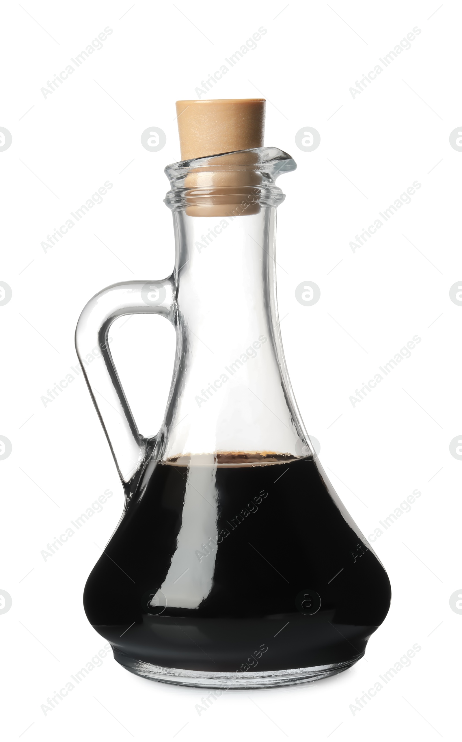 Photo of Balsamic vinegar in glass jug isolated on white