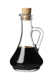 Photo of Balsamic vinegar in glass jug isolated on white