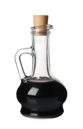 Photo of Balsamic vinegar in glass jug isolated on white