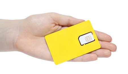 Photo of Woman holding modern SIM card on white background, closeup