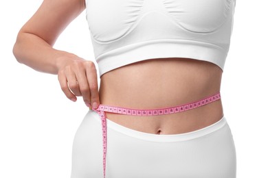 Photo of Diet and weight loss concept. Woman with measuring tape showing her slim body against white background, closeup