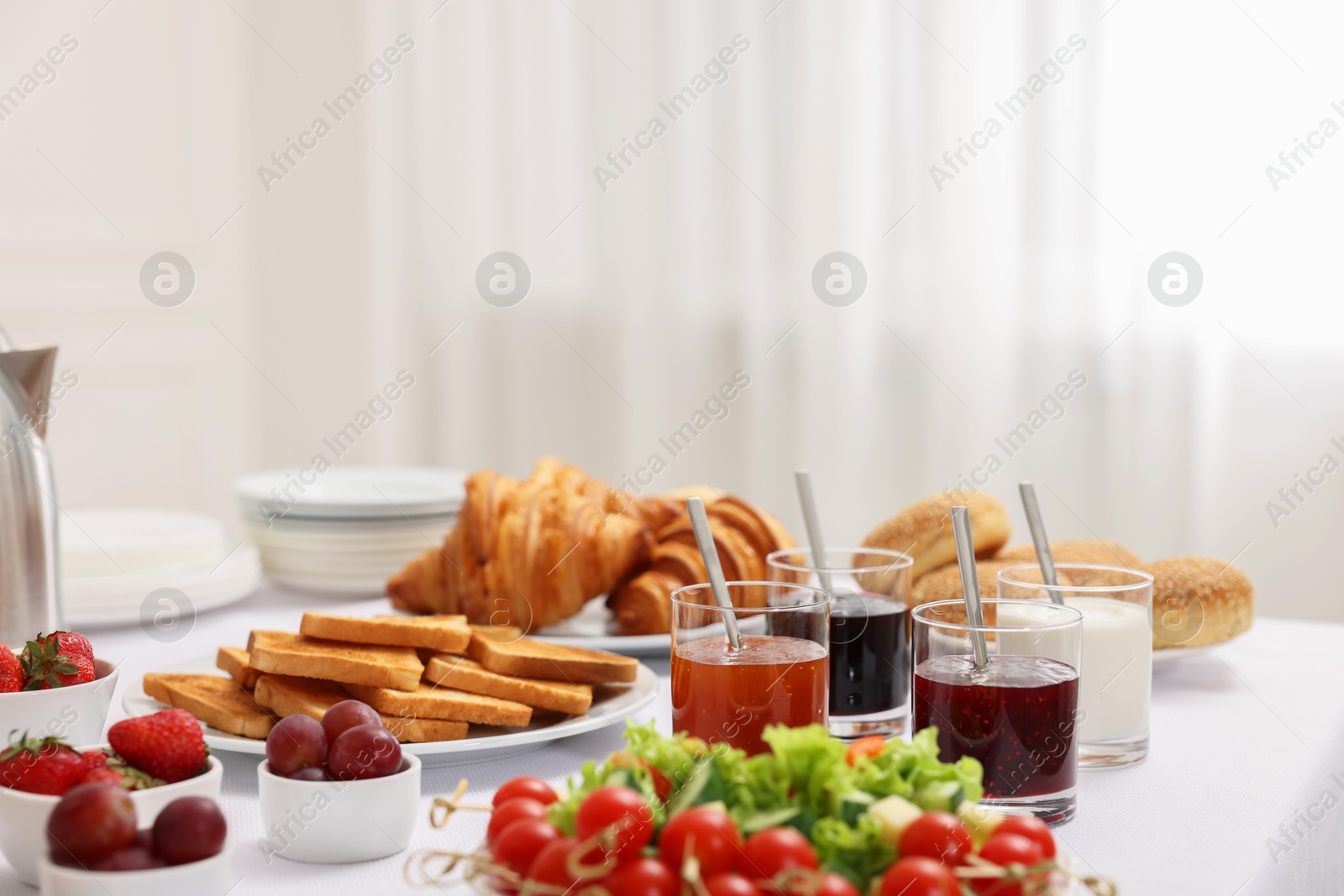 Photo of Different meals served on white table indoors. Buffet menu