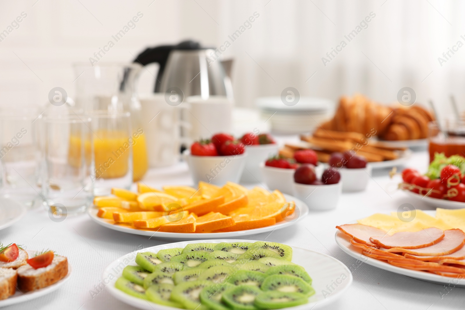 Photo of Different meals served on white table indoors, selective focus. Buffet menu