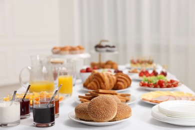 Different meals served on white table indoors. Buffet menu