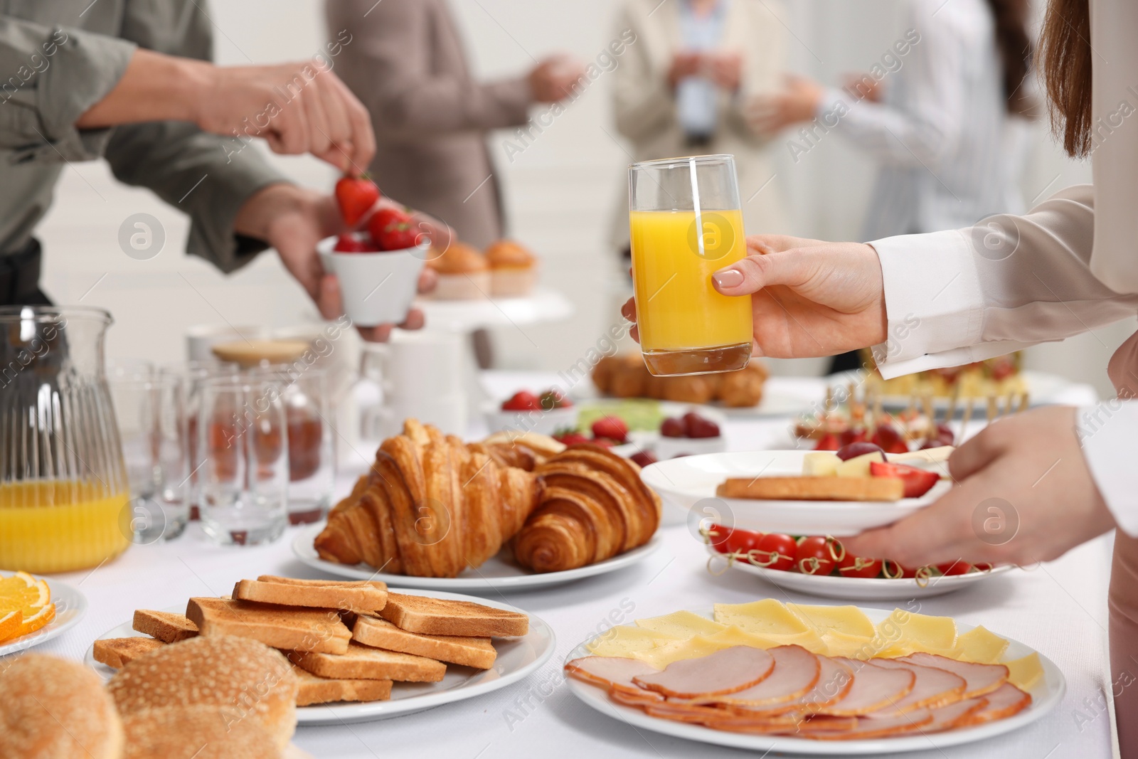 Photo of Coworkers having business lunch in restaurant, closeup