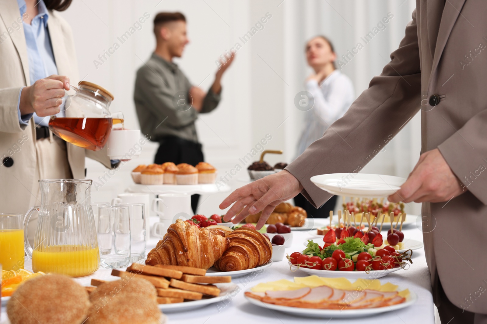 Photo of Coworkers having business lunch in restaurant, closeup