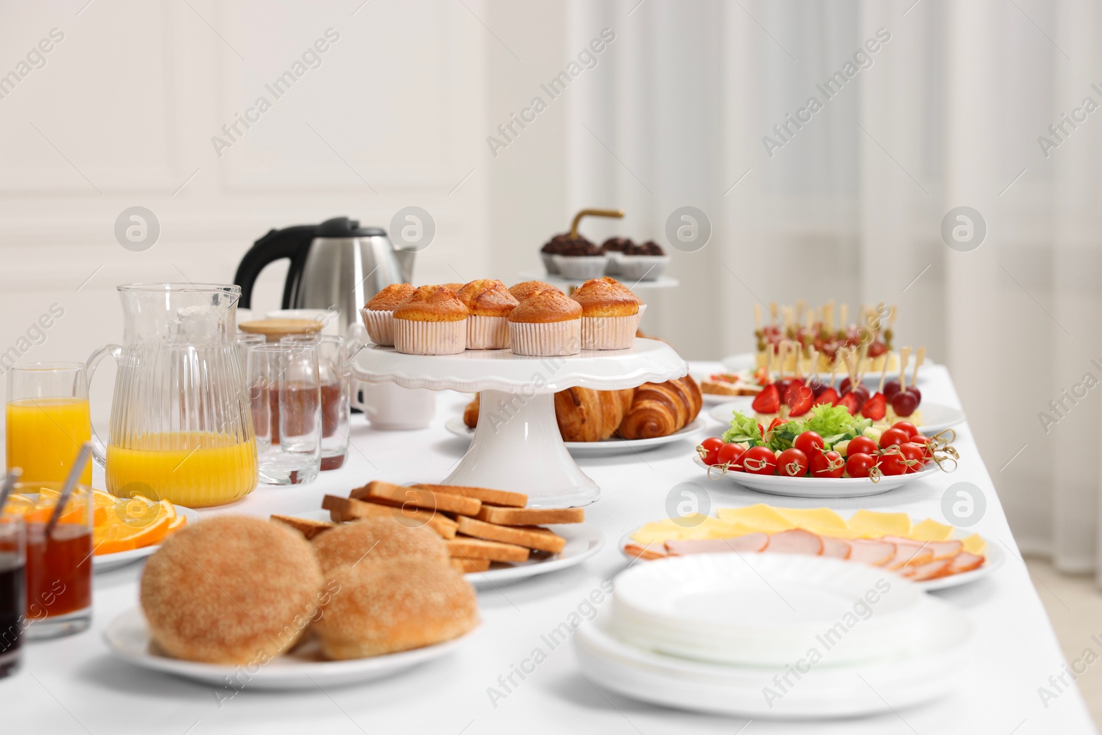 Photo of Different meals served on white table indoors. Buffet menu