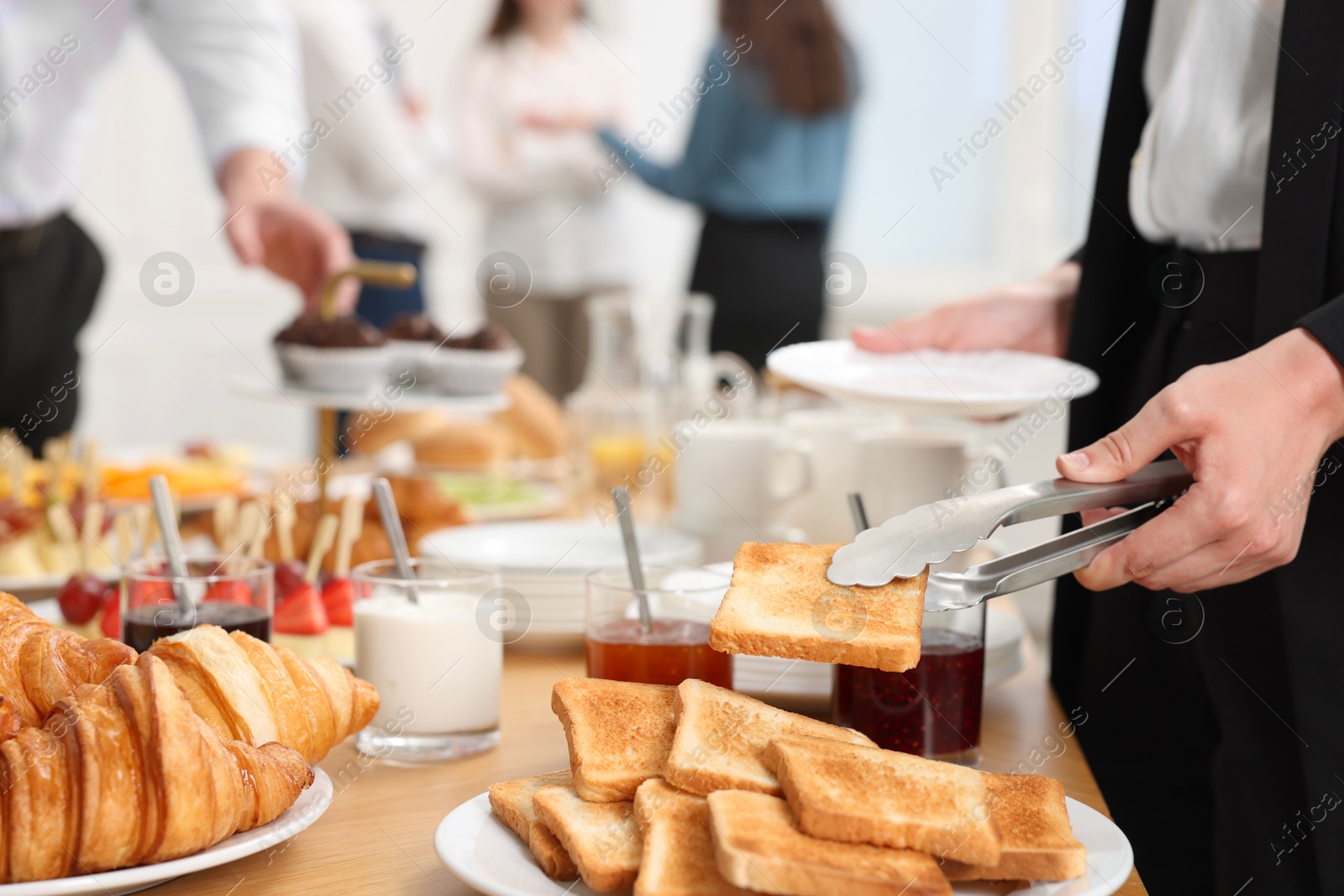 Photo of Coworkers having coffee break in office, closeup