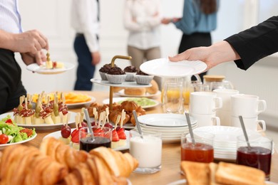 Coworkers having business lunch in restaurant, closeup