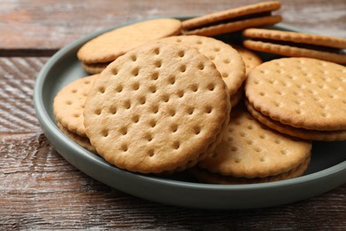 Photo of Tasty sandwich cookies on wooden table, closeup