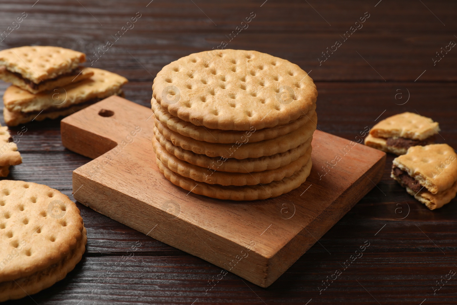 Photo of Tasty sandwich cookies on wooden table, closeup