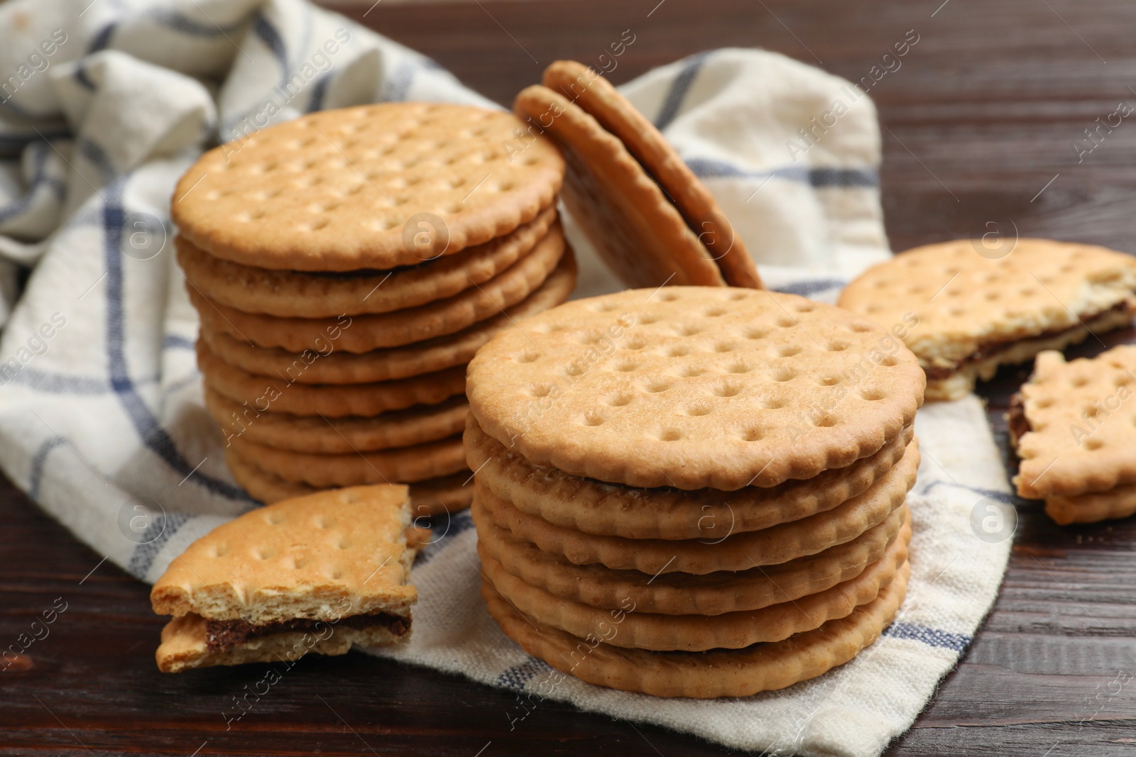 Photo of Tasty sandwich cookies on wooden table, closeup