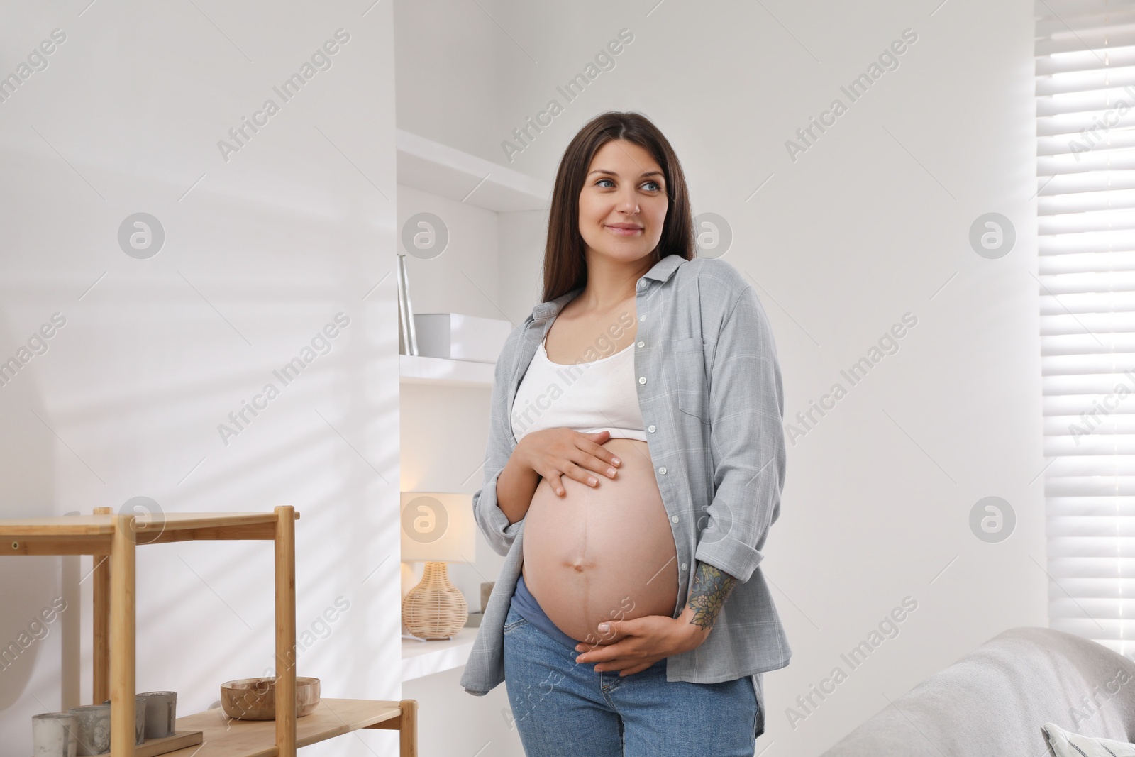 Photo of Portrait of beautiful pregnant woman at home