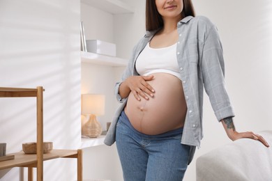 Photo of Pregnant woman in living room, closeup view