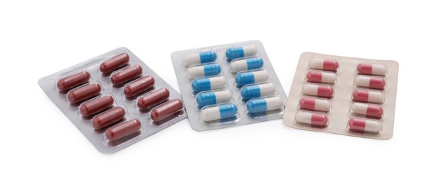 Photo of Different antibiotic pills in blisters isolated on white