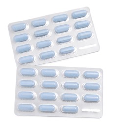 Photo of Antibiotic pills in blisters isolated on white, top view