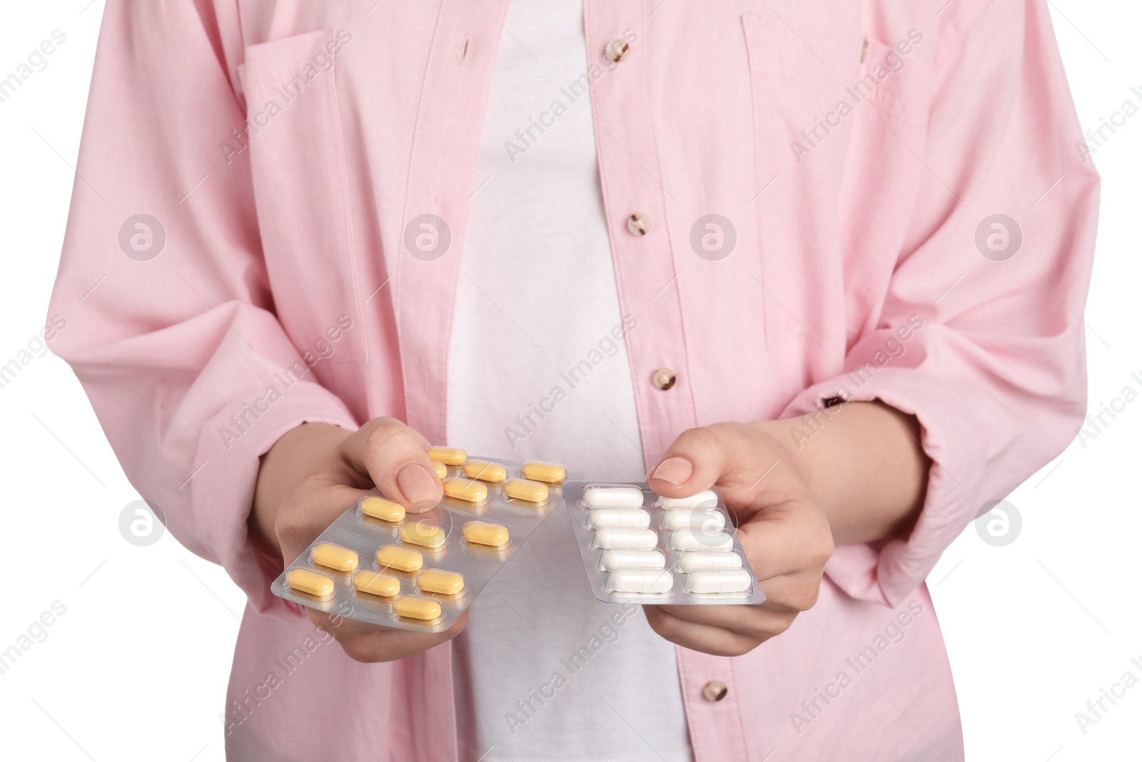 Photo of Woman holding blisters with antibiotic pills on white background, closeup