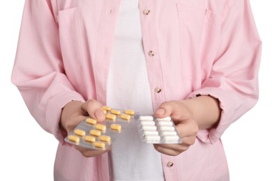 Woman holding blisters with antibiotic pills on white background, closeup