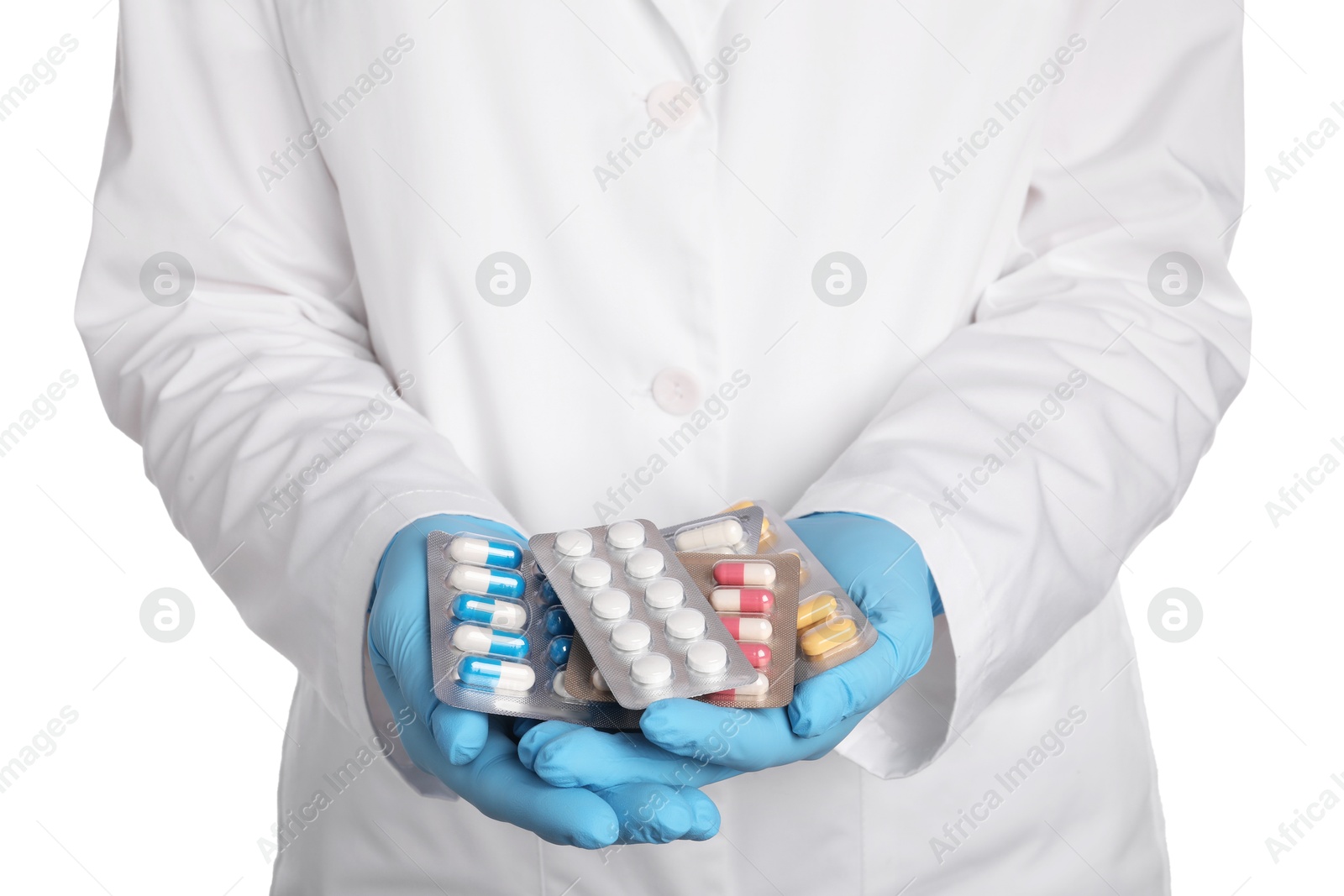 Photo of Doctor holding blisters with antibiotic pills on white background, closeup