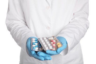 Photo of Doctor holding blisters with antibiotic pills on white background, closeup