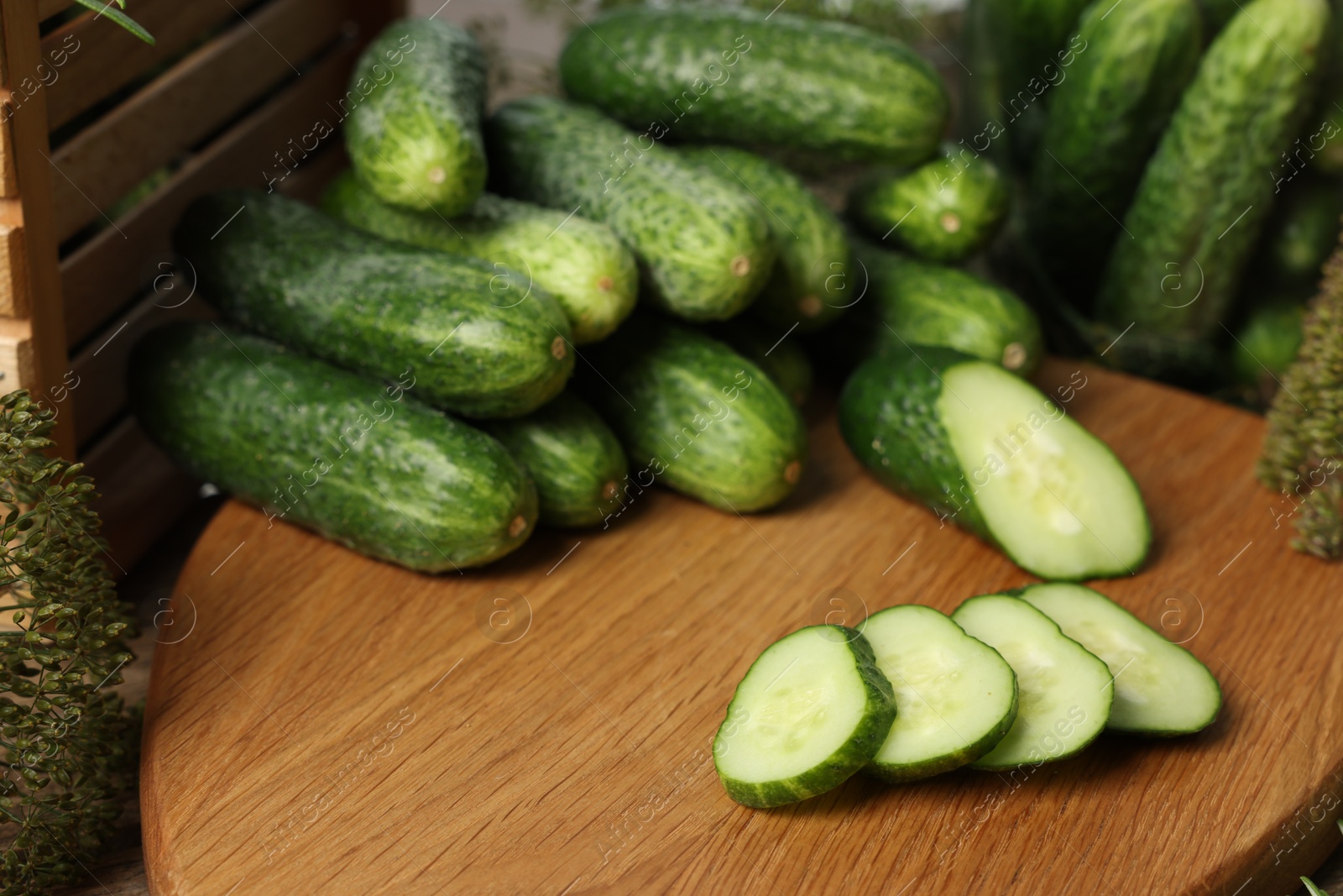 Photo of Fresh cut cucumber on wooden board, closeup