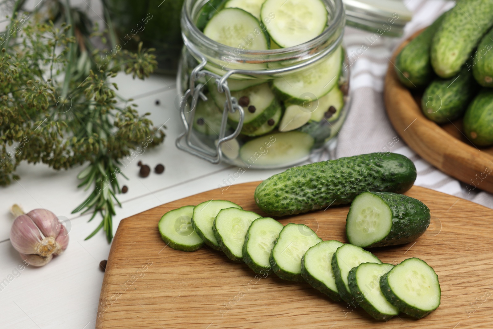 Photo of Fresh cucumbers on light table, closeup. Preparation for pickling