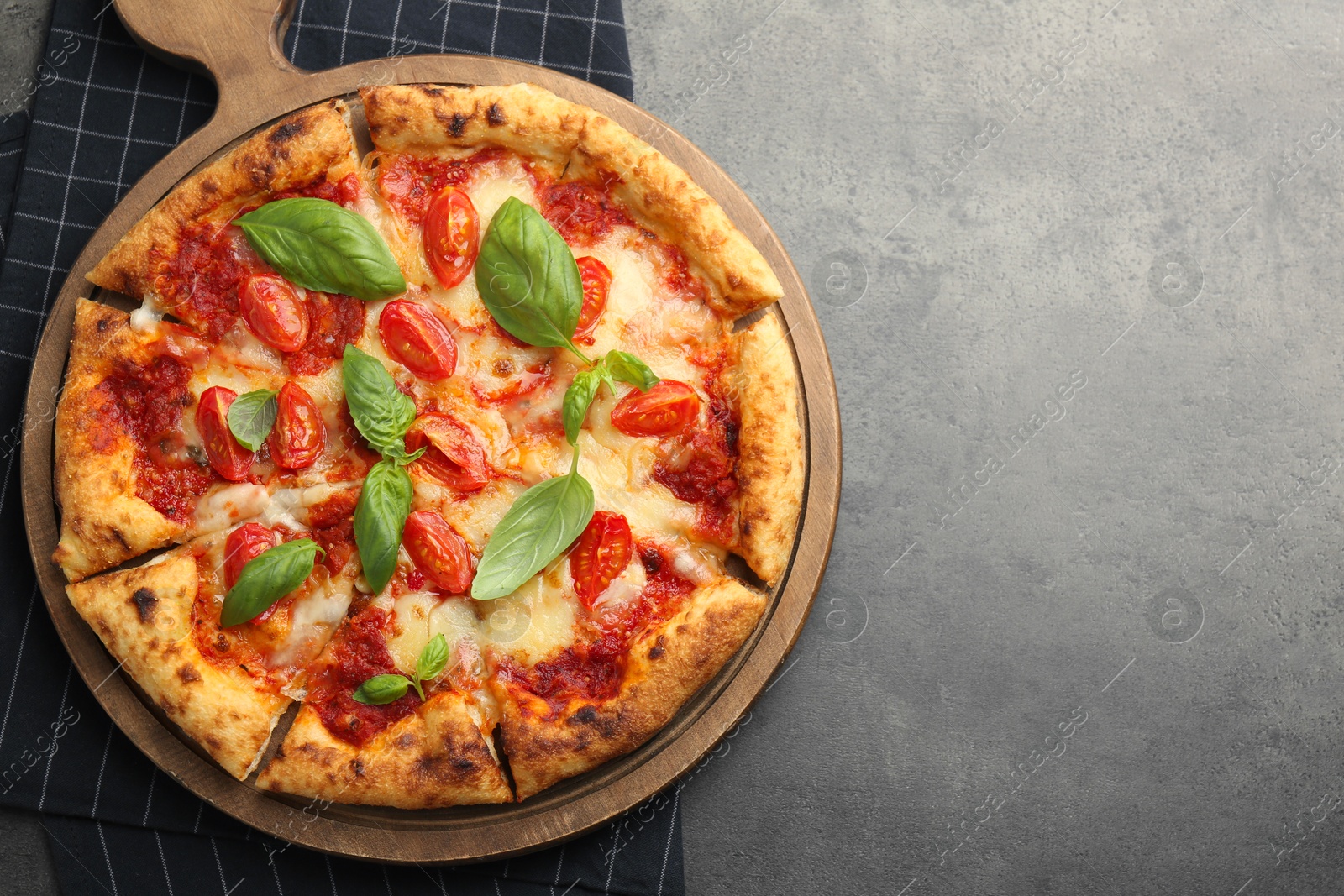 Photo of Delicious Margherita pizza on grey table, top view. Space for text