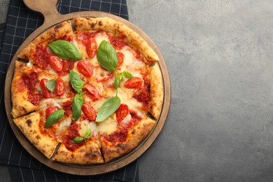 Photo of Delicious Margherita pizza on grey table, top view. Space for text