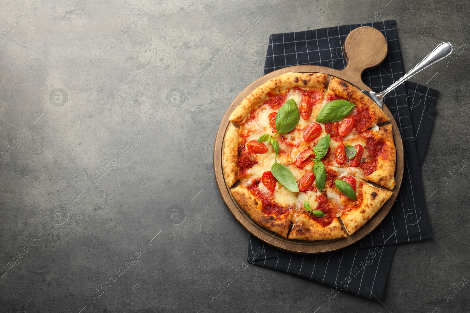 Photo of Delicious Margherita pizza on grey table, top view. Space for text