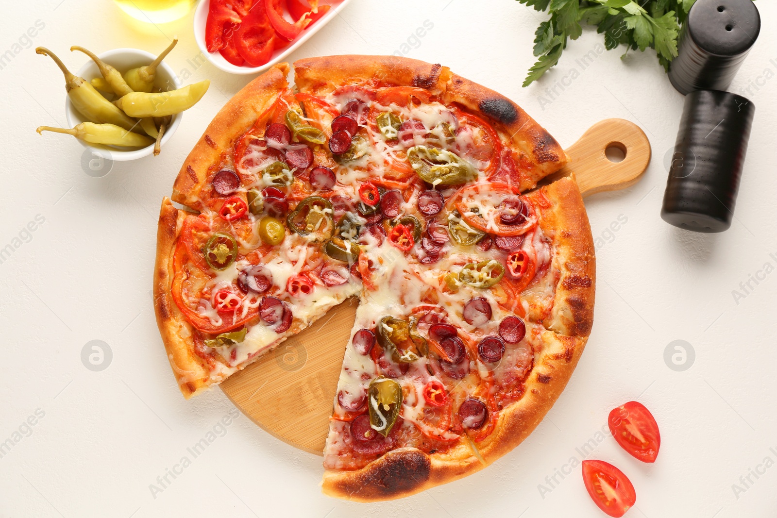 Photo of Delicious pizza Diablo, products and spices on white table, flat lay