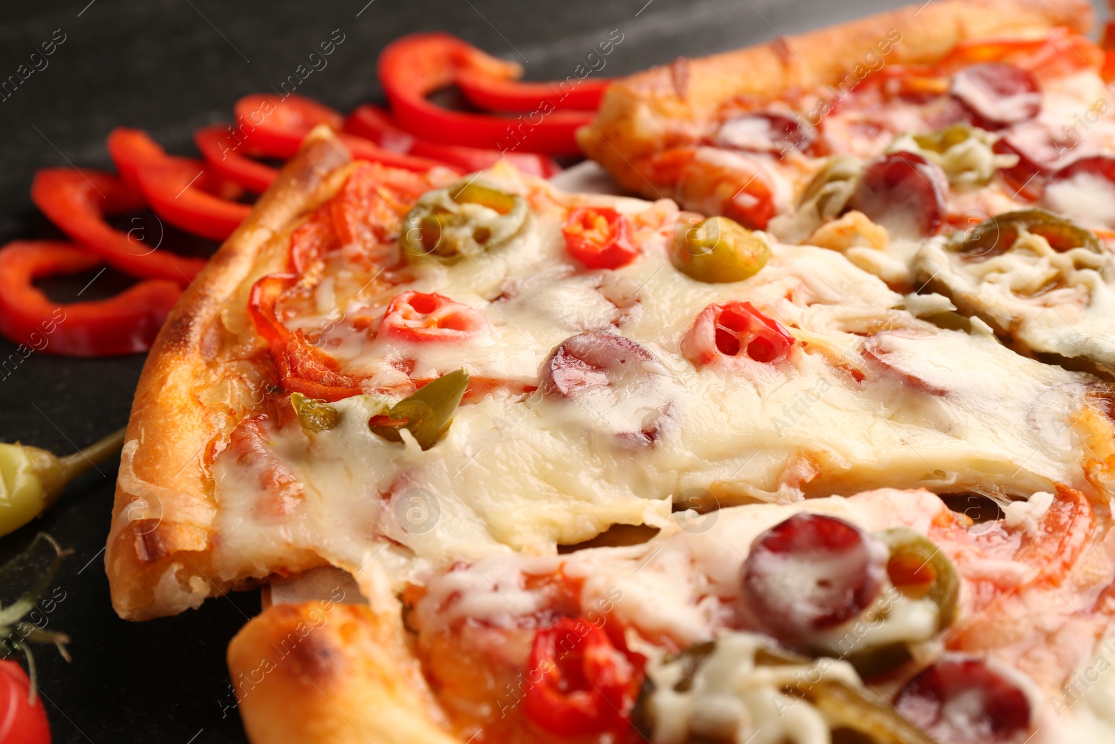 Photo of Delicious pizza Diablo on dark table, closeup