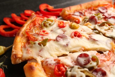 Photo of Delicious pizza Diablo on dark table, closeup