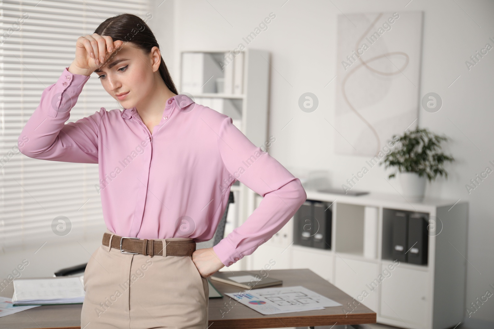 Photo of Embarrassed woman in office, space for text