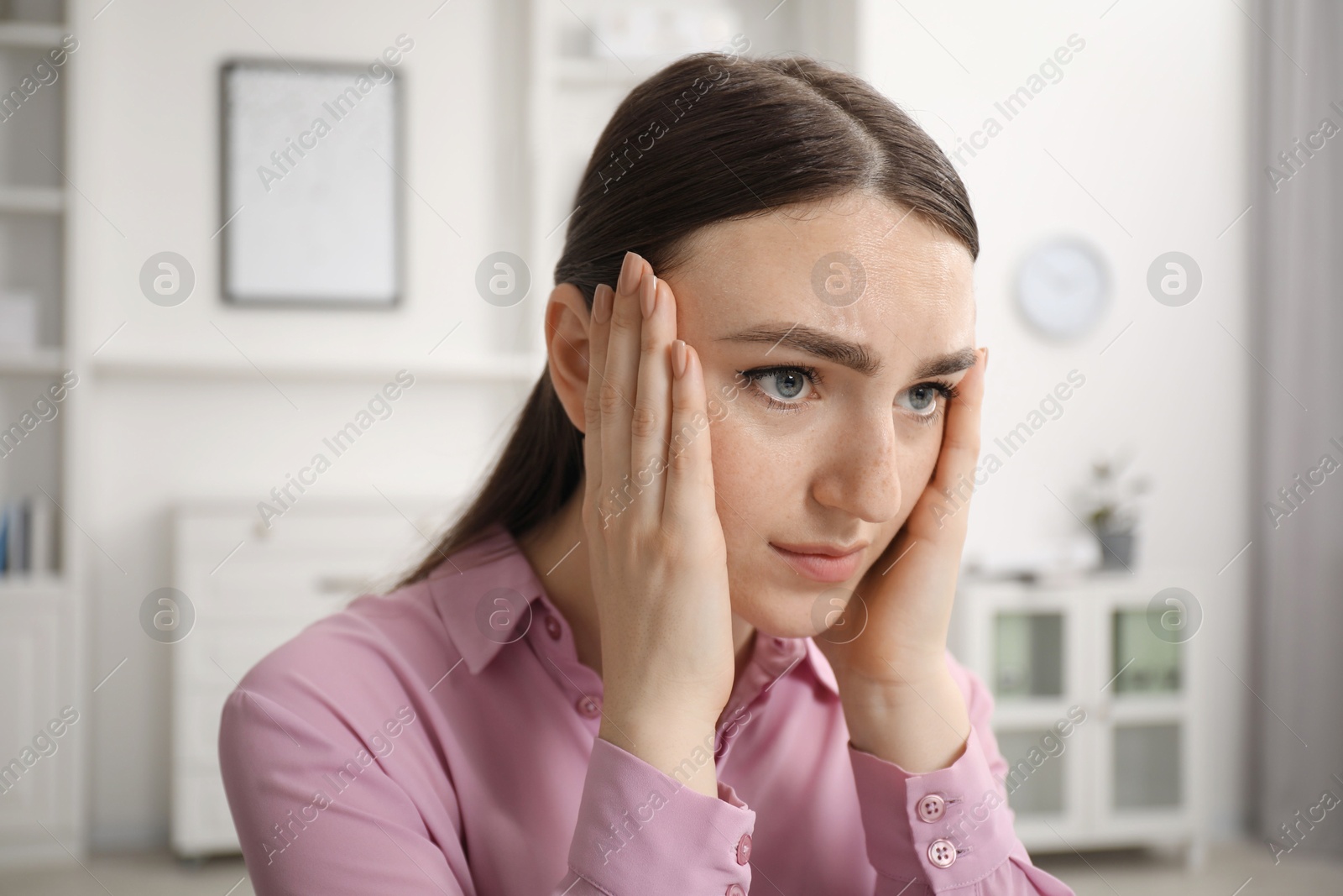 Photo of Portrait of embarrassed young woman in office