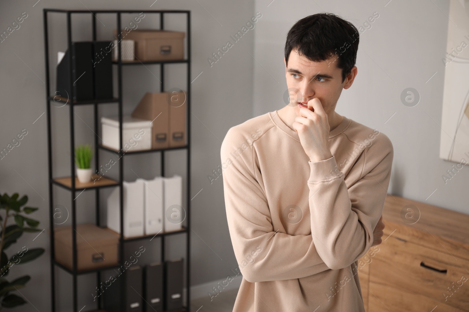 Photo of Portrait of embarrassed young man in office