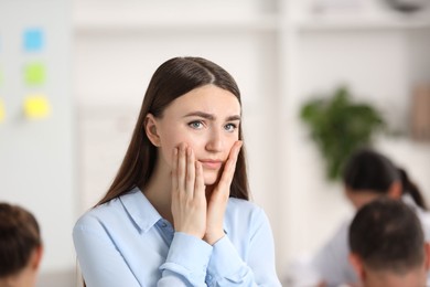 Photo of Woman feeling embarrassed during business meeting in office, space for text
