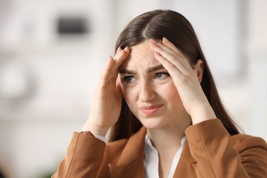 Photo of Portrait of embarrassed young woman in office