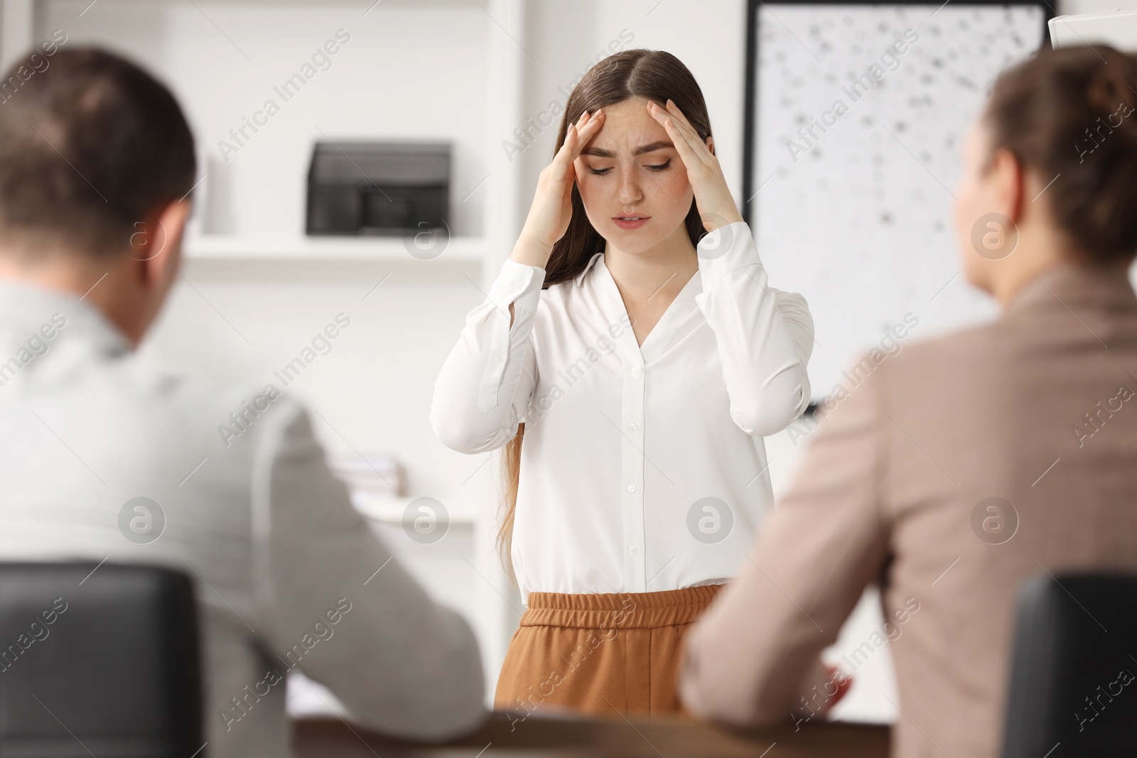 Photo of Woman feeling embarrassed during business meeting in office