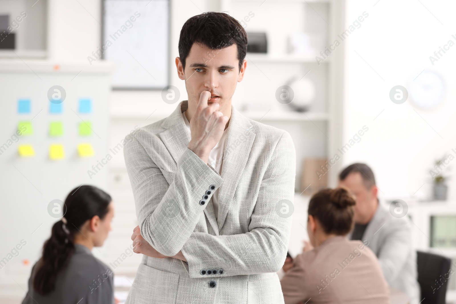 Photo of Man feeling embarrassed during business meeting in office