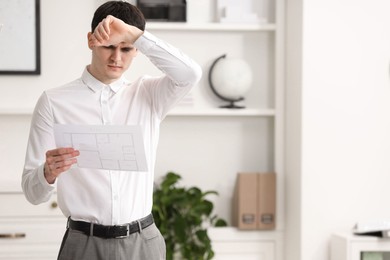 Photo of Embarrassed man with document in office, space for text
