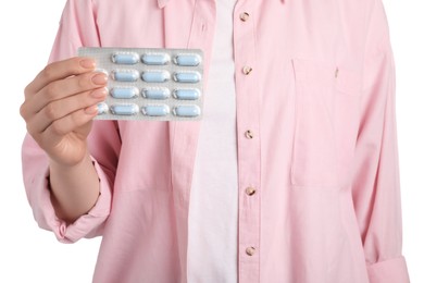 Woman holding blister with antibiotic pills on white background, closeup