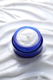 Face cream in jar on cosmetic product, closeup