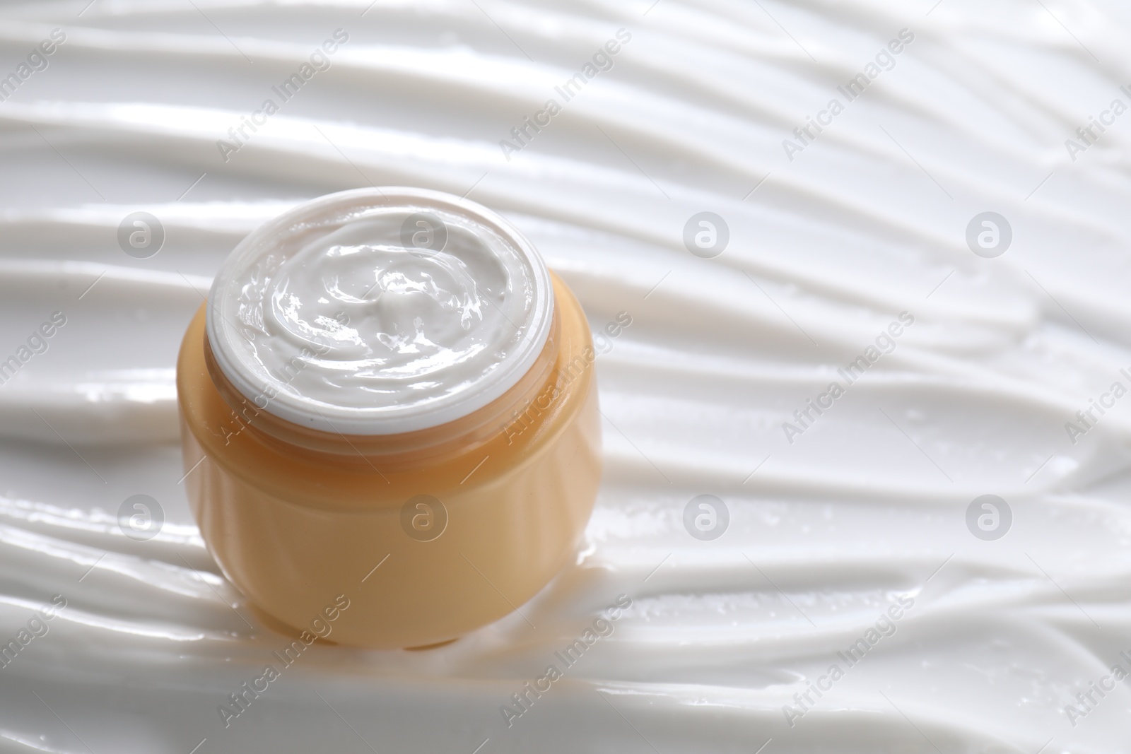 Photo of Jar with face cream, closeup. Space for text