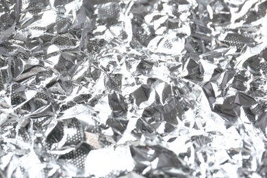 Photo of Shiny silver tinfoil surface as background, closeup